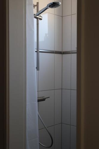 a shower with a shower head in a bathroom at B&B nr.15 in Vries