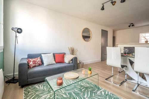 a living room with a couch and a table at Le Coursannais in Coursan