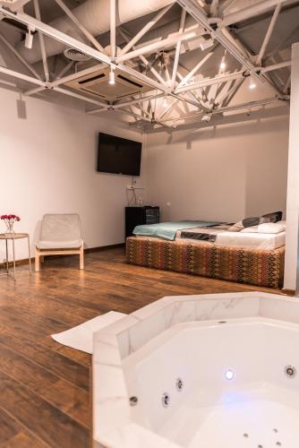 a room with a bath tub and a bed at Avangarda Suites in Belgrade