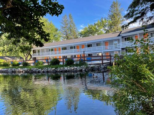 a building next to a body of water at Woodwards White Mountain Resort, BW Signature Collection in Lincoln