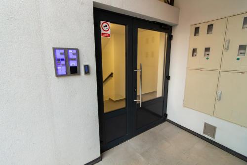 a black door in a building with a no entry sign at Gajeva Rooms - Malmö apartment SELF CHECK-IN in Virovitica