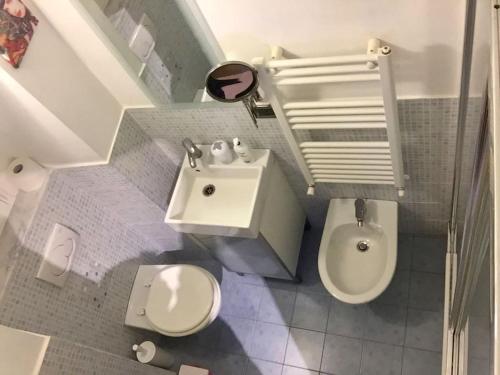 a small bathroom with a toilet and a sink at M Home Genova Sestri Ponente 010025-LT-1596 in Genoa