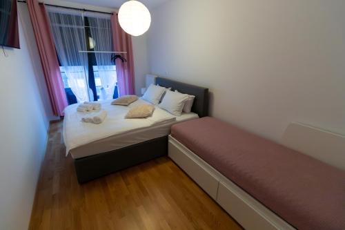 a small bedroom with a bed and a window at Gajeva Rooms - Malmö apartment SELF CHECK-IN in Virovitica