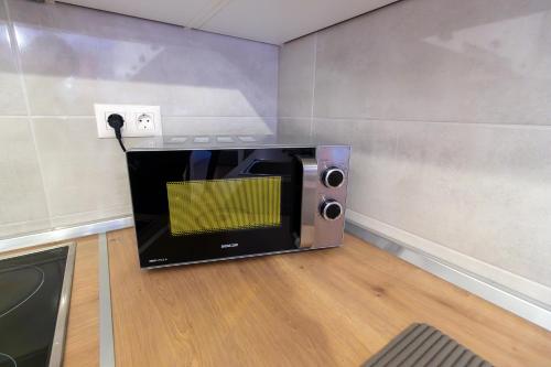 a microwave oven sitting on the floor in a room at Gajeva Rooms - Malmö apartment SELF CHECK-IN in Virovitica