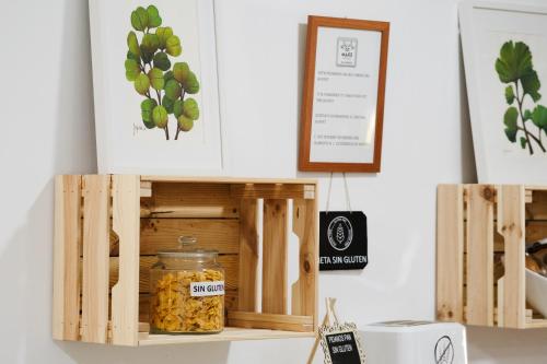 a shelf with wooden boxes with a jar of food at Hotel Isla Menor in Dos Hermanas