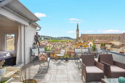 a balcony with chairs and a view of a city at Dante - Sweet Dreams in Florence in Florence