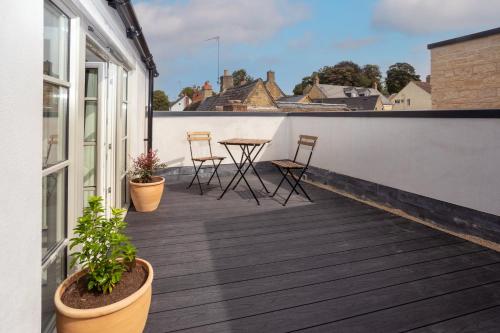 a balcony with chairs and a table on a building at 30 Chipping Norton - Luxury Holiday Apartments in Chipping Norton