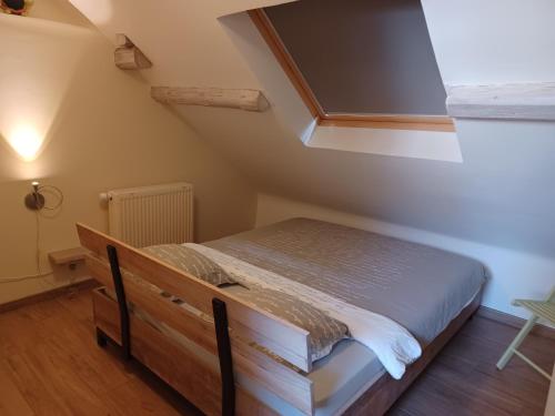 a bedroom with a bed in the attic at de ploeg luxe in Bullange