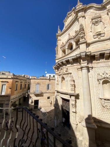an old building with a fence in front of it at Roiss Haus Suites in Lecce