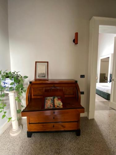 a wooden dresser in a room with a bedroom at Roiss Haus Suites in Lecce