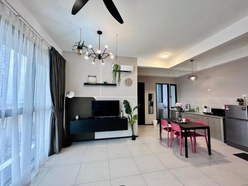 a living room with a table and a kitchen at Urban Suite Cozy Family Homestay at Georgetown by URBAN STAYCATION HENG LOD in Jelutong