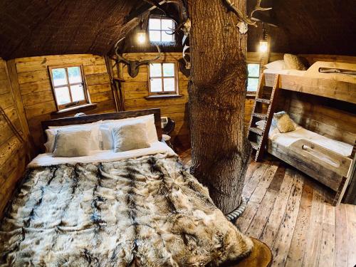 a bedroom with two beds in a log cabin at Luxury Airstream Retreat in Tonbridge