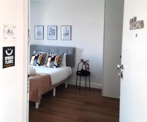 a bedroom with a bed with pillows on it at Smiling Places - Apartment in Porto in Porto