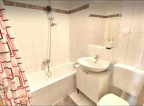 a bathroom with a sink and a toilet and a tub at Studio next to Karlsplatz/Karlskirche in Vienna