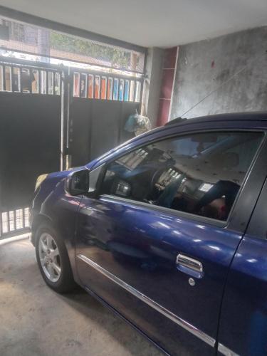 a blue car parked in front of a garage at homesweethome 