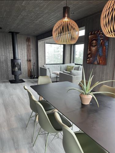 a dining room with a table and chairs at Stylish cabin at Lifjell with jacuzzi and sauna in Bø