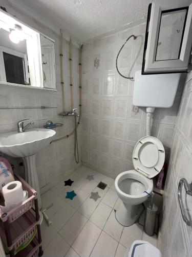 a bathroom with a toilet and a sink at Sunny Peraia Apartment in Perea