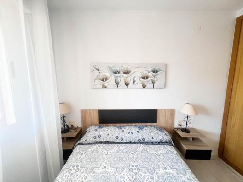 a bedroom with a bed with three elephants on the wall at Espacio ideal en la Playa in Oropesa del Mar