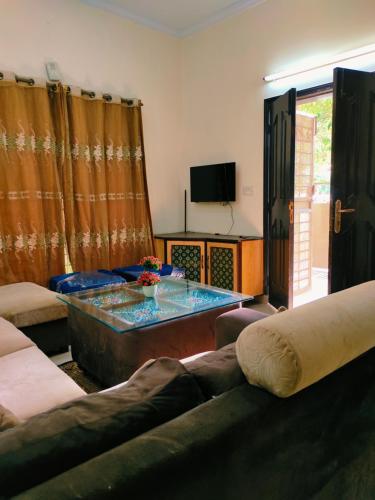 a living room with a couch and a table at 2 bedrooms house for families in Lahore