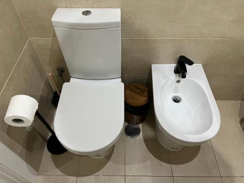 a bathroom with a toilet and a sink at Estoril Casino 3 Bedrooms With Pool in Estoril