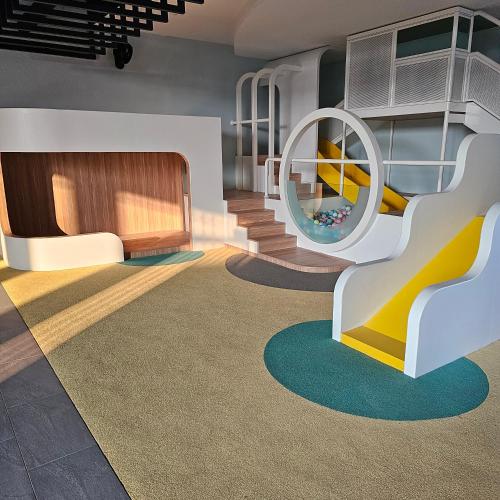 a childrens play room with a slide and a playground at Societe Suites By iHost Global in Kuala Lumpur