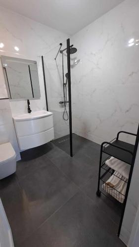 a white bathroom with a sink and a mirror at Cazare cartier Milano in Oradea