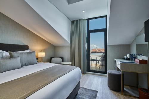 a hotel room with a bed and a large window at Rayelin Hotel Istanbul Old City Special Category in Istanbul