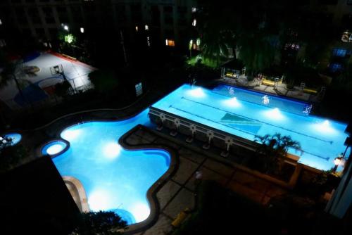 an overhead view of a swimming pool at night at Bi-level unit with City View in San Andres