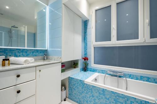 une salle de bain avec un lavabo et un miroir dans l'établissement Veeve - Amber Blush, à Paris