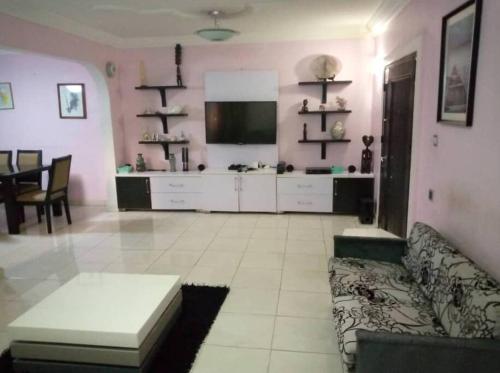 a large living room with a couch and a kitchen at 1-bedroom apartment in dolphin in Lagos