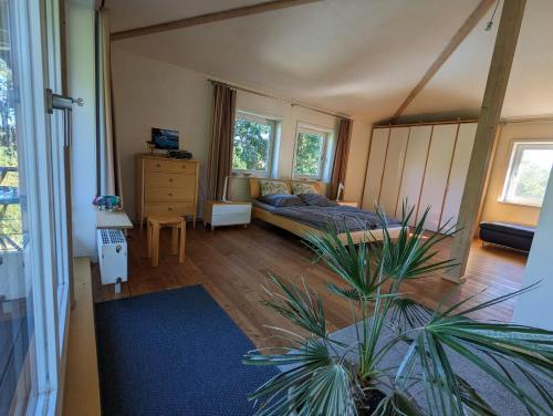 a bedroom with a bed and a potted plant at "Buena Vista" Ashausen/Hamburg in Stelle