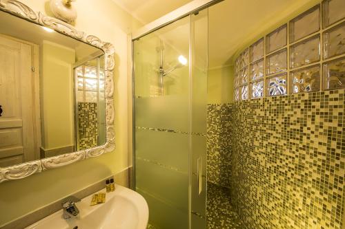 a bathroom with a glass shower and a sink at B&B Lambroriver in Merone