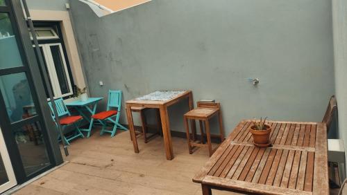 a room with benches and tables in a room at Parede beach in Almada