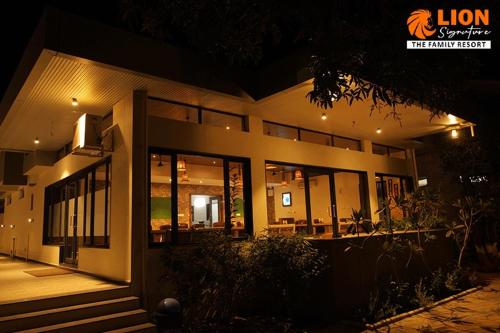 a building with a lot of windows at night at Lion Signature Family Resort in Sasan Gir