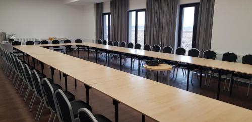 a row of tables and chairs in a room at Gościniec Uniejów in Uniejow