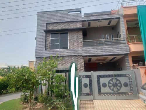 a house with a surfboard in front of it at 2 bedrooms house for families in Lahore