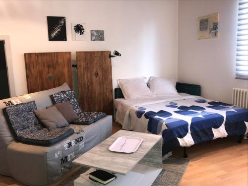 ein Wohnzimmer mit einem Bett und einem Sofa in der Unterkunft CasaSavernoise O SONHO in Saverne