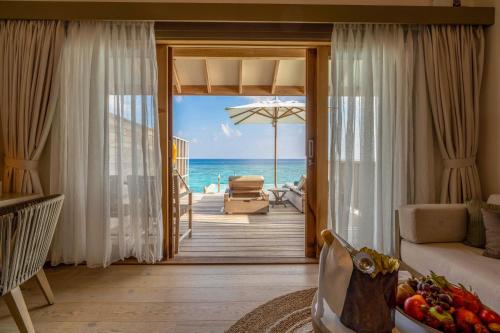 a living room with a view of the ocean at Kagi Maldives Resort & Spa in North Male Atoll