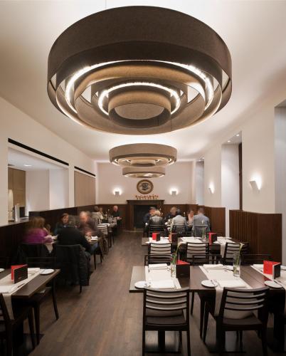 a dining room with people sitting at tables in a restaurant at Eden Hotel Früh am Dom in Cologne
