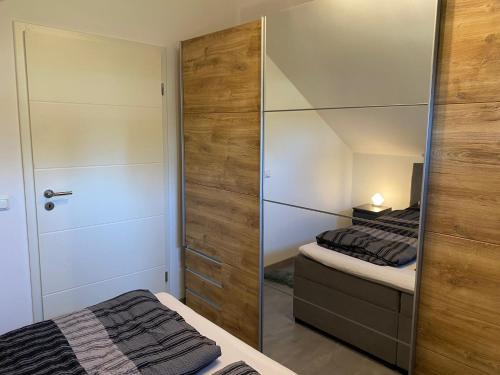 a bedroom with two beds and a mirrored closet at Dachterrassenwohnung Alois in Passau