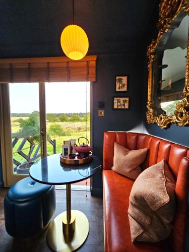 a living room with a couch and a table at Lavish Country Retreat 30mins Taxi Ride From West London in Chessington