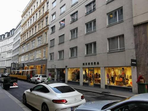 a white car parked in front of a building at Luxury Living First District in Vienna