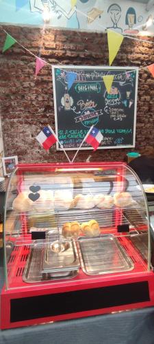 a display case with a bunch of donuts and a sign at Hostal Providencia in Santiago