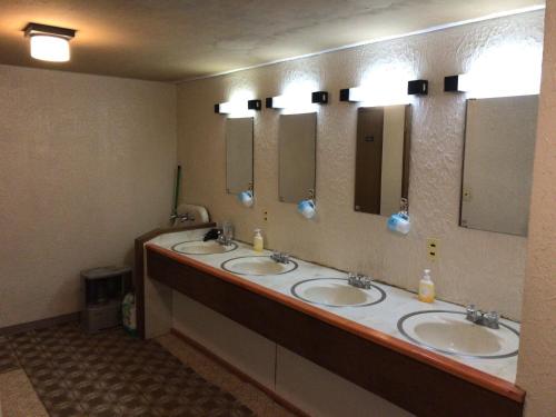 a bathroom with three sinks and three mirrors at New Togakushi Sea Hail - Vacation STAY 51752v in Nagano