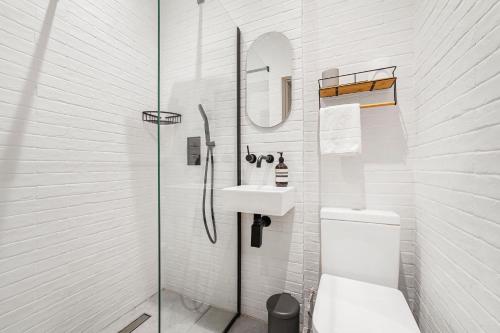 a bathroom with a toilet and a sink and a shower at Newly Refurbished Warehouse Cnv 2BR Apt Bermondsey in London