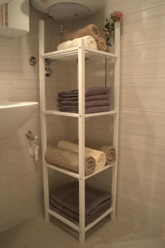 a white towel rack in a bathroom with towels at Central Apartment Adria in Rovinj