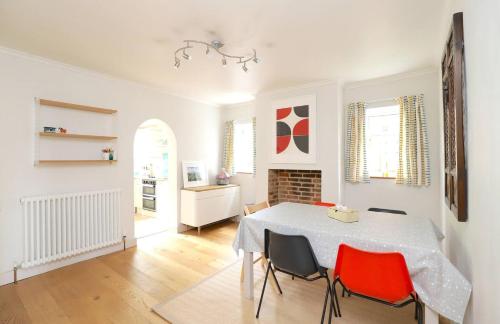a white dining room with a table and chairs at Pass the Keys Victorian 3 Bed inc Parking Garden Headington in Oxford