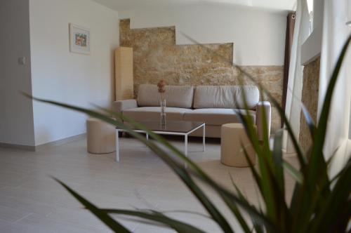 a living room with a couch and a table at Central Apartment Adria in Rovinj