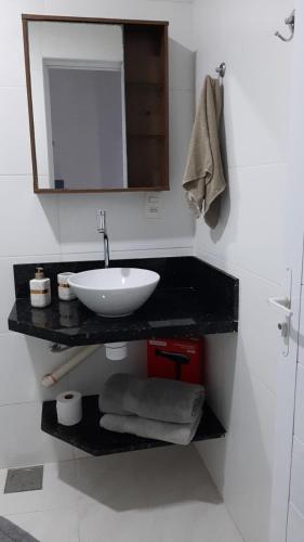 a bathroom with a sink and a mirror at Pé na areia in Rio de Janeiro