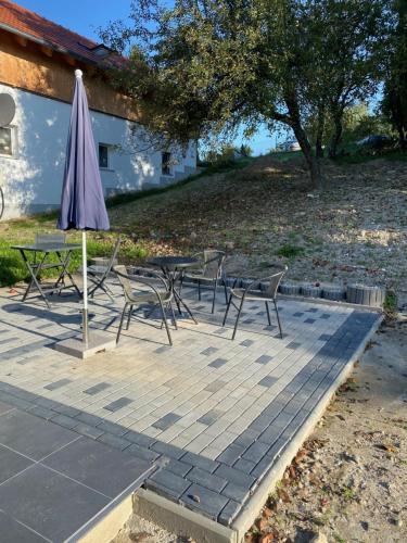 a patio with a table and chairs and an umbrella at Ferienwohnung Valentin in Passau